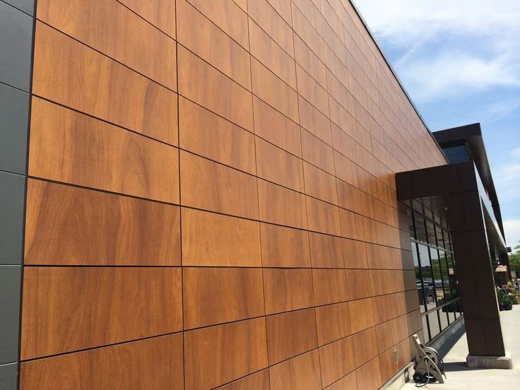Yashvi Infra Co team installing HPL high pressure laminate cladding on building exterior in Ahmedabad Gujarat